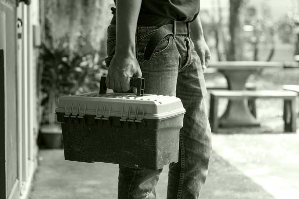 Man carrying work toolbox.